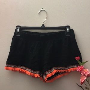 Girls black and orange shorts with fringe